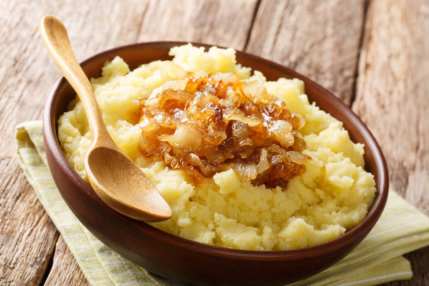 Organic boiled potatoes with caramelized onions close-up on a pl - Fotografie, Obrázek