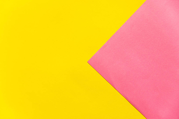 Yellow and pink paper background. Abstract background. Colorful background with copy space. - 写真・画像