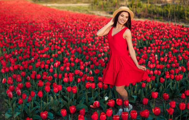 Optimistic lady walking amidst flowers - Fotoğraf, Görsel
