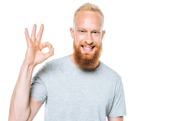 smiling man in grey t-shirt showing ok sign, isolated on white - Φωτογραφία, εικόνα
