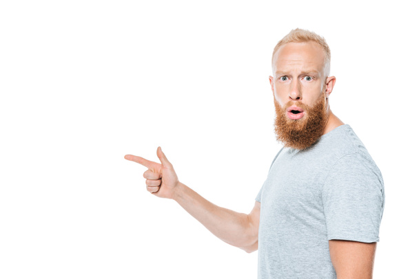 shocked bearded man in grey t-shirt pointing isolated on white - Foto, Imagem