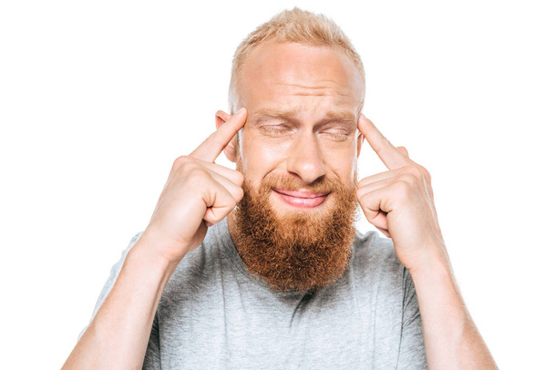 handsome bearded man having headache, isolated on white - Foto, afbeelding