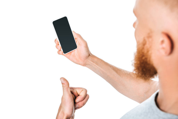 cropped view of man holding smartphone with blank screen and showing thumb up, isolated on white - Fotografie, Obrázek