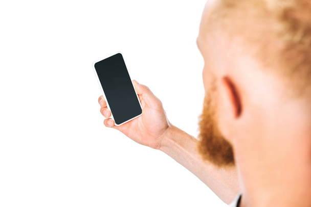 cropped view of man looking at smartphone with blank screen, isolated on white - Foto, immagini