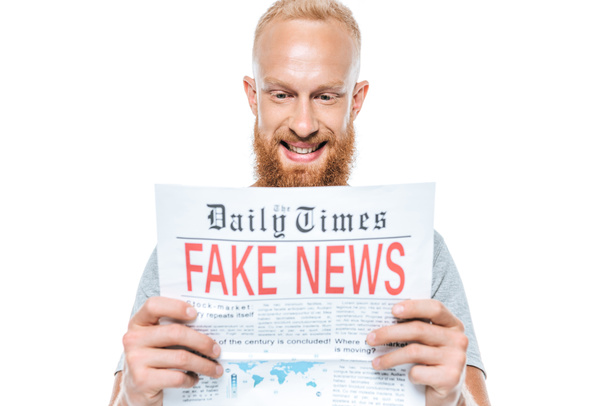 cheerful bearded man reading newspaper with fake news, isolated on white - Foto, immagini