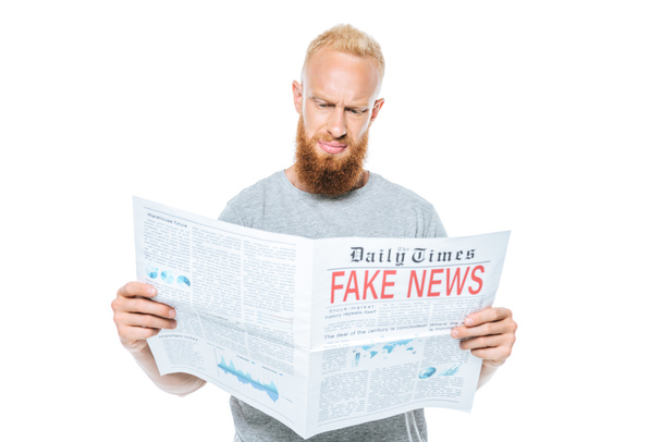 skeptical bearded man reading newspaper with fake news, isolated on white - Fotoğraf, Görsel