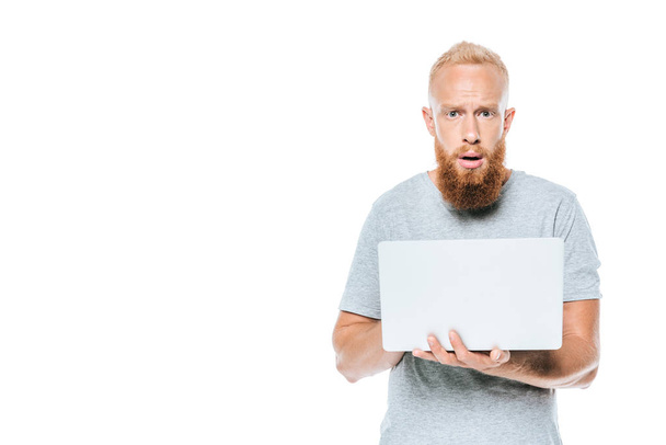 shocked bearded man using laptop, isolated on white - Foto, Bild
