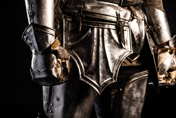 cropped view of knight in armor isolated on black - Φωτογραφία, εικόνα