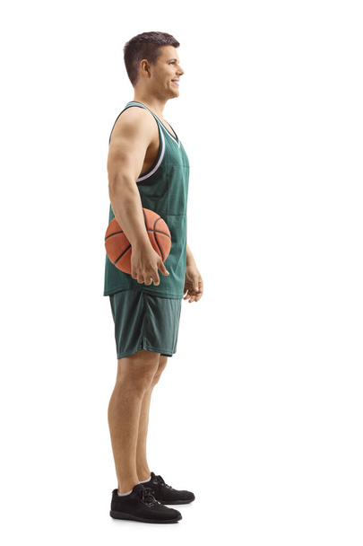 Basketball player with a ball under his arm - Valokuva, kuva