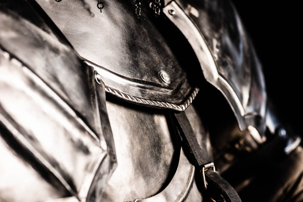 cropped view of knight in armor isolated on black  - Φωτογραφία, εικόνα
