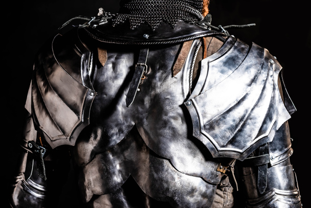cropped view of knight in armor isolated on black - Photo, Image