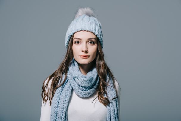 beautiful elegant woman posing in knitted hat and scarf, isolated on grey - Photo, Image