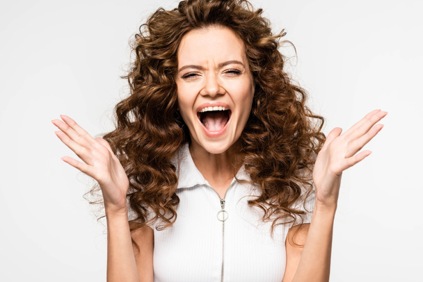 excited curly girl screaming in white t-shirt, isolated on white - Photo, Image