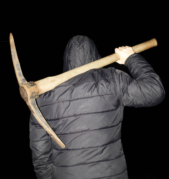 Scary evil man at night with an axe isolated in black background - Фото, зображення