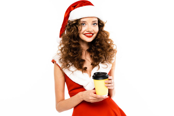 krásná usmívající se žena v kostýmu Santa drží kávu jít, izolované na bílém - Fotografie, Obrázek