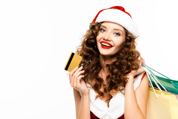 beautiful woman in santa hat holding credit card, isolated on white - Fotó, kép