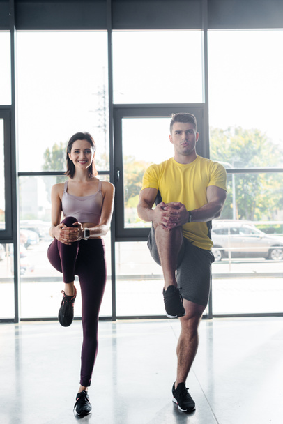 sportsman and sportswoman working out together in sports center - Фото, изображение