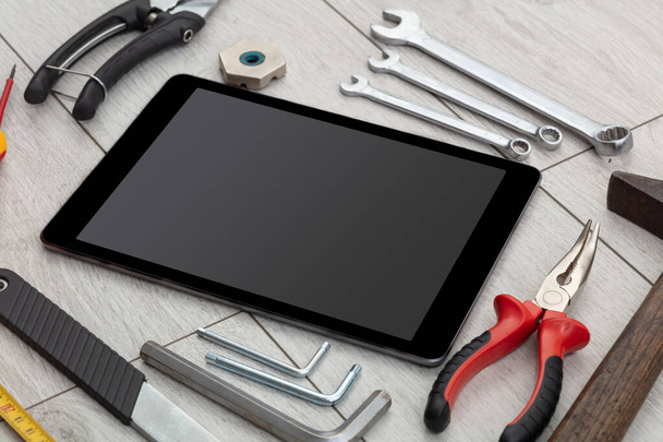 Household tools and tablet with empty screen - Foto, afbeelding