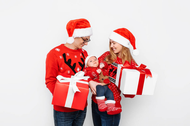 Happy family, mom, dad and little baby with christmas gifts isolated on white background - Foto, Imagem
