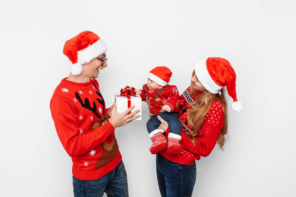Happy family, dad mom and little baby, celebrate Christmas and g - Фото, зображення
