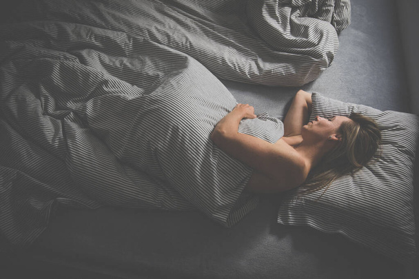Pretty, middle-aged woman sleeping in her bed at home - Fotoğraf, Görsel
