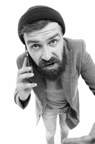 Mobile call concept. Important conversation. Man bearded hipster hold mobile phone white background. Stylish guy use mobile phone. Difficulties mobile communication. Hipster smartphone call friend - Фото, изображение