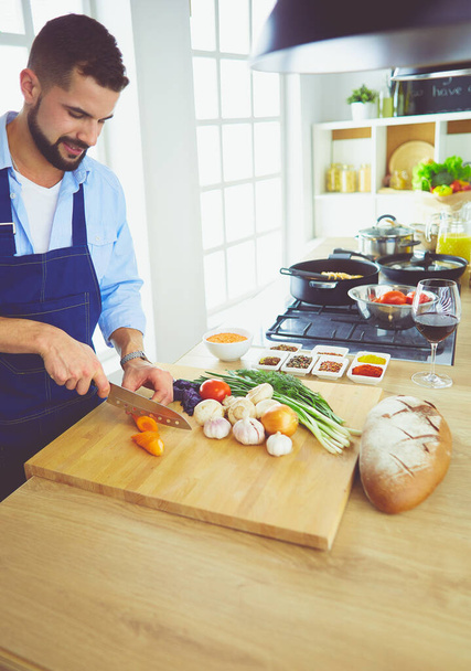 Man preparing delicious and healthy food in the home kitchen - 写真・画像