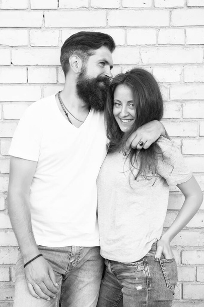 Just hang out together. Couple in love. Family couple hugging on brick wall background. Bearded man and sexy woman cuddling. Sensual couple together. Family day. Careful hug of loving people - Foto, Imagen