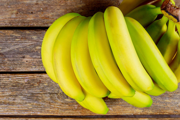 Bunch of bananas ripe on a wooden table. - Foto, Bild