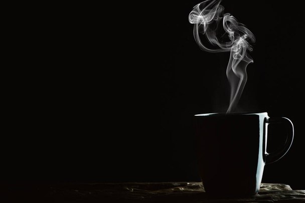 beverage background of hot coffee, tea or chocolate in black mug - Fotó, kép