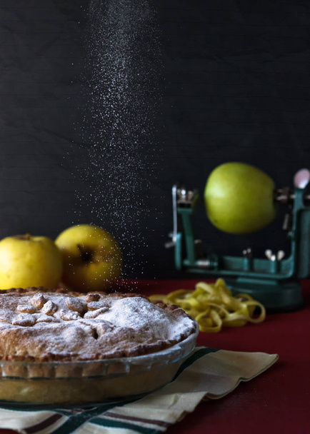 Apple pie with sugar rain. Black background with apples. Food concept - Photo, Image