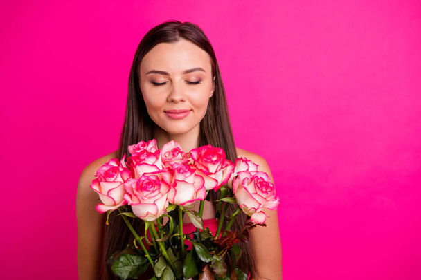 Close-up portrait of her she nice attractive lovely calm peaceful cheerful long-haired girl holding in hands smelling bouquet isolated on bright vivid shine vibrant pink fuchsia color background - Fotoğraf, Görsel