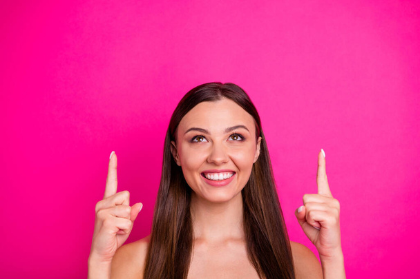 Closeup photo of funny lady indicating fingers looking up empty space showing low price novelty naked shoulders isolated vibrant pink color background - Valokuva, kuva