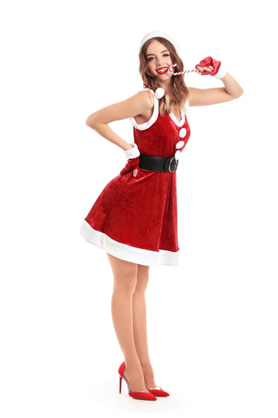 Beautiful woman dressed as Santa with candy cane on white background - Foto, afbeelding