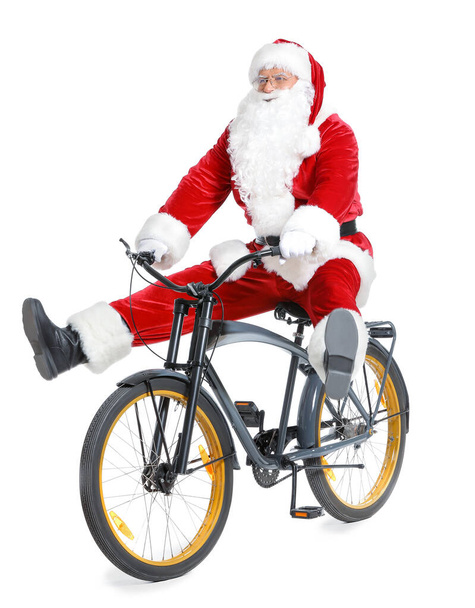 サンタクロースは白い背景に自転車に乗る - 写真・画像