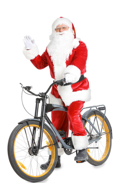 Joulupukki polkupyörällä valkoisella taustalla
 - Valokuva, kuva