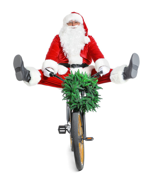 Santa Claus їздить на велосипеді на білому тлі. - Фото, зображення