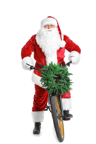 Санта Клаус з велосипедом на білому тлі. - Фото, зображення