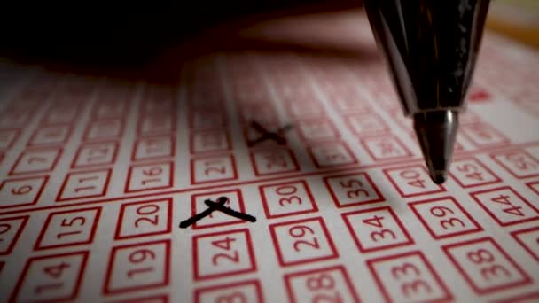 hand fill out lottery ticket. cross out lucky numbers on play slip - Footage, Video
