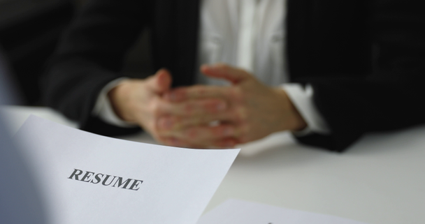hiring manager interviews a woman in a job interview reviewing resume - Video, Çekim