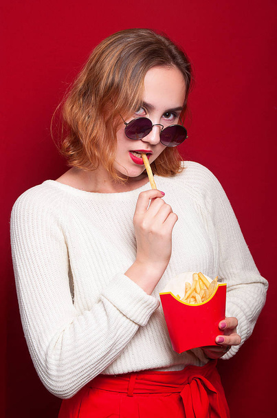 beautiful girl with French fries and drink - Zdjęcie, obraz