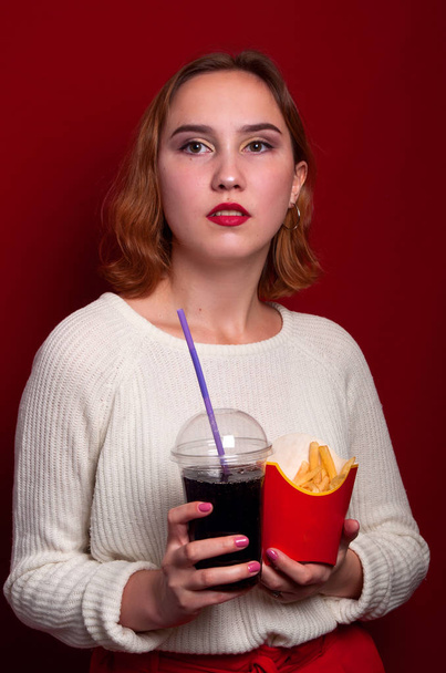 beautiful girl with French fries and drink - Fotó, kép
