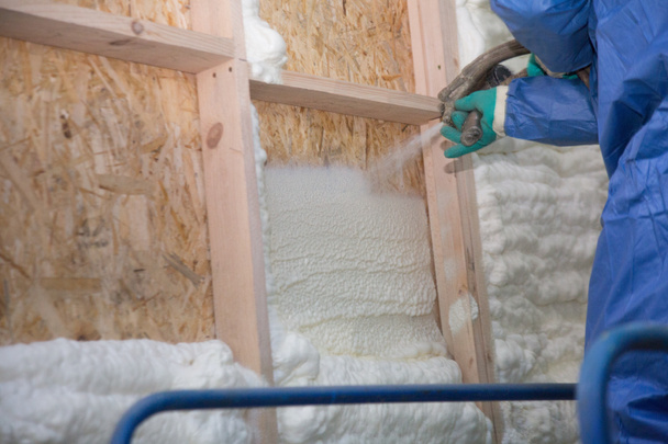 Foam is applied to the walls to warm the house - Photo, Image
