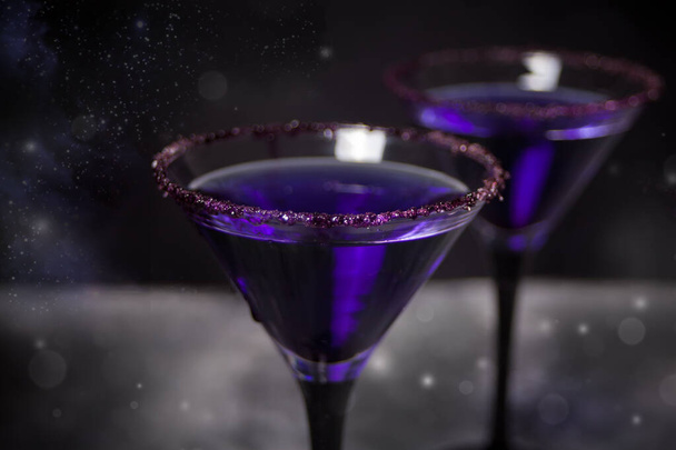 Two glasses with purple cocktail for Halloween party on the dark background - Φωτογραφία, εικόνα