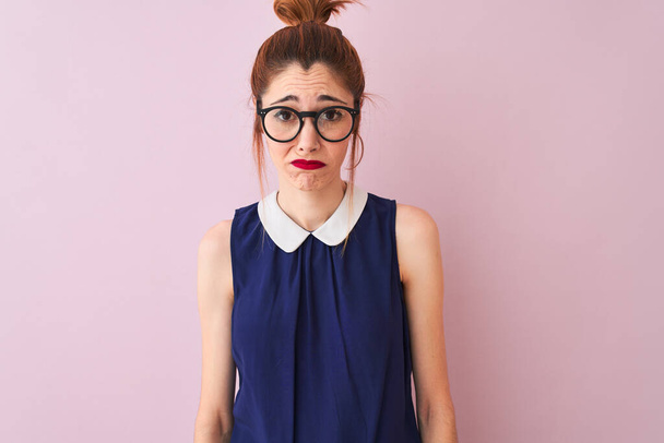 Redhead woman with pigtail wearing elegant dress and glasses over isolated pink background depressed and worry for distress, crying angry and afraid. Sad expression. - Φωτογραφία, εικόνα