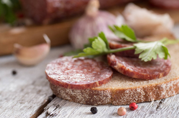 salami and bread on a wooden board - Foto, Imagem