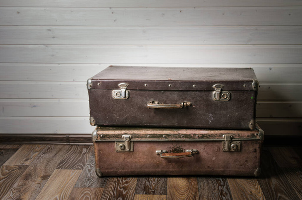 Vintage leather suitcase on white wall. - Photo, Image