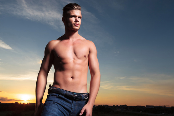 topless man looks away during sunset - Photo, Image