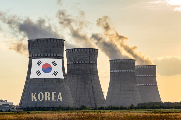 Nuclear plant chimneys displaying flag of Korea, Republic of wit - 写真・画像