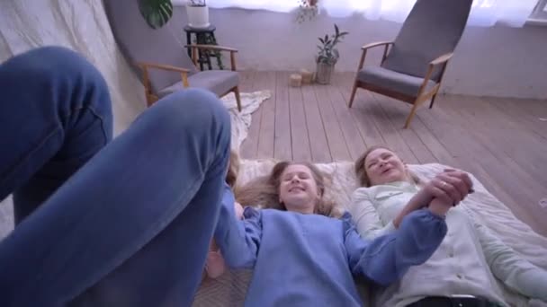 family love, happy mother with daughters together have fun time and fall on bed - Materiał filmowy, wideo
